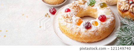 Three kings holiday festive fruitcake topped with colorful candied fruits on a table, background Three kings holiday festive fruitcake topped with colorful candied fruits on a table, background 121149740