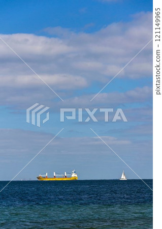 Container ship on sea with copy space on heaven and water, sunny day Container ship on sea with copy space on heaven and water, sunny day 121149965