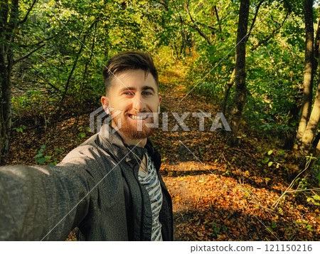 Handsome man is taking a selfie outdoor - caucasian people - nature, people, lifestyle and technology concept Handsome man is taking a selfie outdoor - caucasian people - nature, people, lifestyle and technology concept 121150216