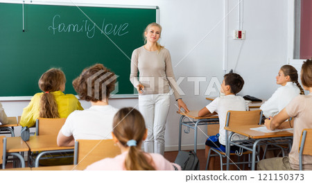 Female teacher giving lesson to children in school Female teacher giving lesson to children in school 121150373