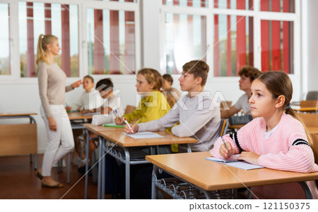 Young boys and girls studying in classroom Young boys and girls studying in classroom 121150375