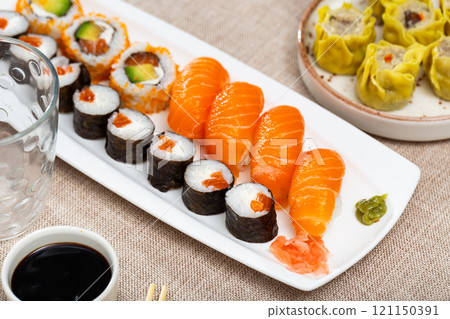 Sushi set con maki with uramaki rolls and salmon nigiri with plate dumplings sio mai 121150391
