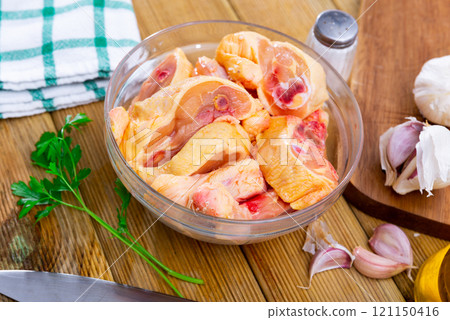 Bowl with raw sliced chicken, food preparation 121150416