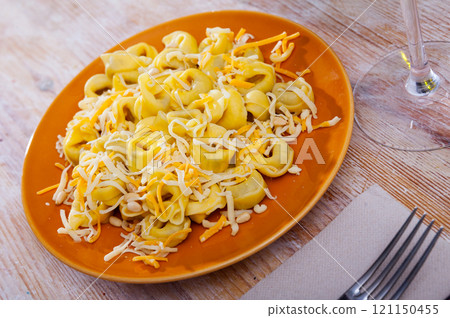 Small appetizing ravioli with cheese on the table 121150455