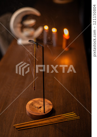 Smoke from burning incense sticks standing on incense holder 121150804