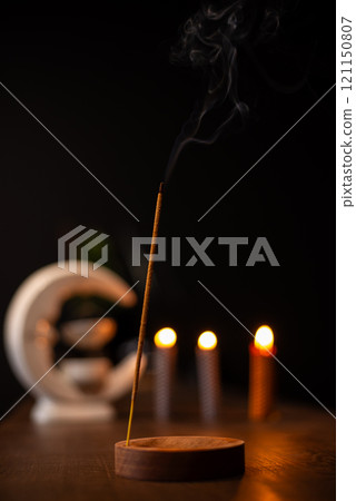 Smoke from burning incense sticks standing on incense holder 121150807