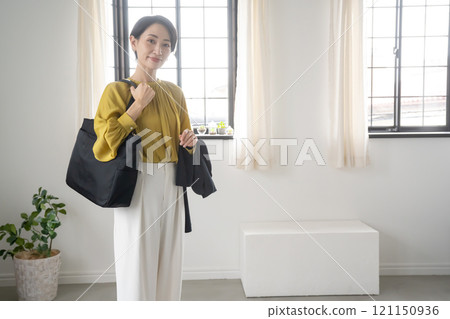 Woman with bag and jacket indoors Woman with bag and jacket indoors 121150936