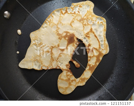 Crooked, unfinished talentless pancake is cooked 121151137
