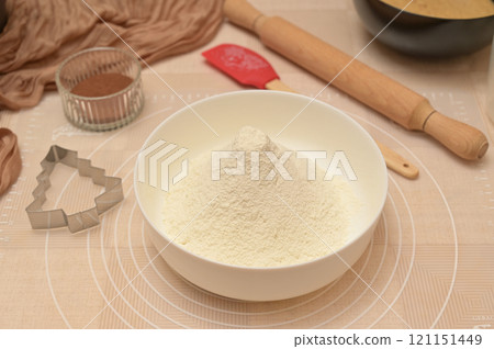 Christmas homemade baking, ingredients for baking gingerbread, sifted flour in a white bowl 121151449