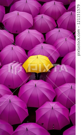 Purple umbrellas create a vibrant pattern, with a single yellow umbrella standing out in the center, symbolizing individuality and uniqueness, AI 121151579