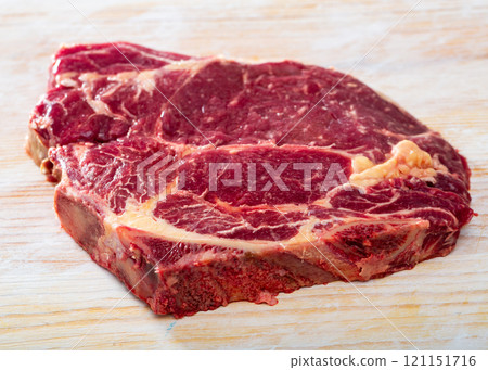 Fresh chop of beef on natural wooden background, nobody 121151716