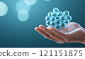 Hand holding a 3D molecular structure model against a blurred blue background, AI 121151875