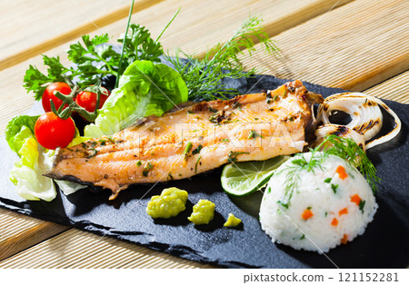 Grilled trout fillet with rice, vegetables, greens Grilled trout fillet with rice, vegetables, greens 121152281