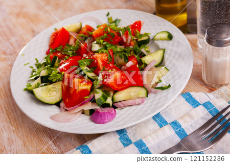 Fresh salad with cucumbers, tomatoes and onion 121152286