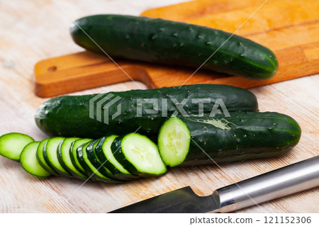 Whole and sliced fresh cucumbers Whole and sliced fresh cucumbers 121152306