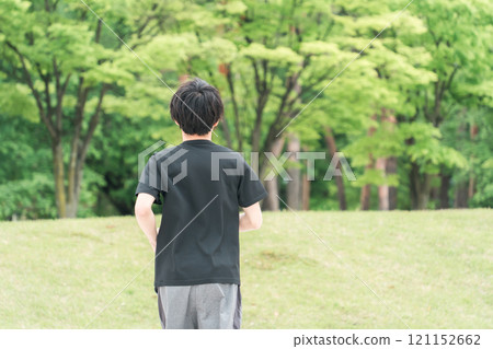 Young man walking/jogging/running/exercising/aerobic exercise/training in the park 121152662