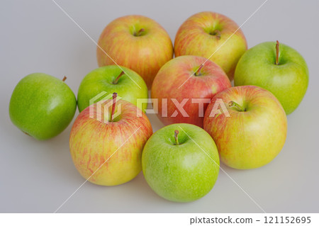 Red and green apples on a gray background thin focus part. Fruit, apple. Red and green apples on a gray background thin focus part. Fruit, apple. 121152695