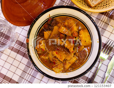 Portion of stewed tripe is cooked in plate - stomach of cattle Portion of stewed tripe is cooked in plate - stomach of cattle 121153407