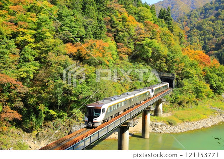 Takayama Main Line Limited Express Hida train running with autumn leaves in the background Takayama Main Line Limited Express Hida train running with autumn leaves in the background 121153771