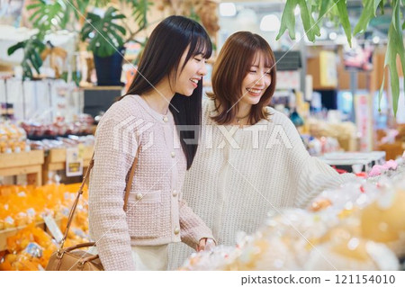 Women enjoying shopping at the market Women enjoying shopping at the market 121154010