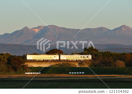 The Soya Main Line Rapid Nayoro train running with Mount Daisetsu in the background JR Hokkaido H100 DECMO 121154302