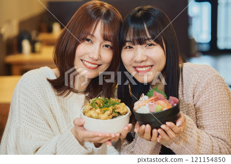 Women eating seafood bowls. Photo courtesy of Peer Bandai. Women eating seafood bowls. Photo courtesy of Peer Bandai. 121154850