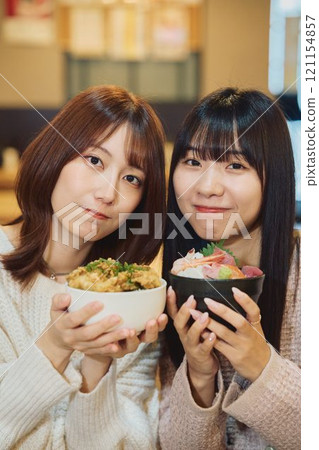 Women eating seafood bowls. Photo courtesy of Peer Bandai. Women eating seafood bowls. Photo courtesy of Peer Bandai. 121154857