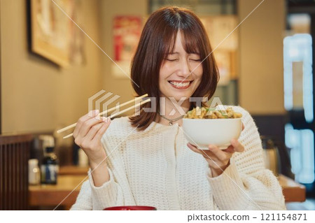 A woman eating a seafood bowl with gusto. Photo courtesy of Peer Bandai. 121154871