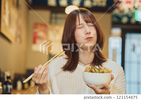 A woman eating a seafood bowl with gusto. Photo courtesy of Peer Bandai. A woman eating a seafood bowl with gusto. Photo courtesy of Peer Bandai. 121154875