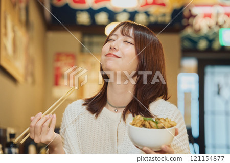 A woman eating a seafood bowl with gusto. Photo courtesy of Peer Bandai. 121154877