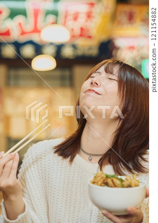 A woman eating a seafood bowl with gusto. Photo courtesy of Peer Bandai. A woman eating a seafood bowl with gusto. Photo courtesy of Peer Bandai. 121154882
