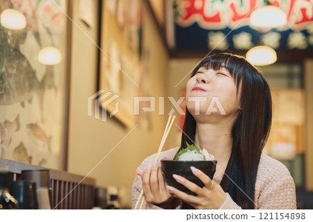 A woman eating a seafood bowl with gusto. Photo courtesy of Peer Bandai. A woman eating a seafood bowl with gusto. Photo courtesy of Peer Bandai. 121154898