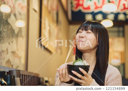 A woman eating a seafood bowl with gusto. Photo courtesy of Peer Bandai. A woman eating a seafood bowl with gusto. Photo courtesy of Peer Bandai. 121154899