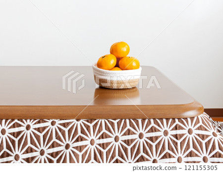 A basket of tangerines on a kotatsu table 121155305