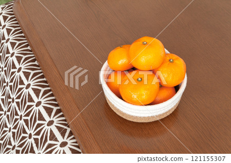 A basket of tangerines on a kotatsu table 121155307