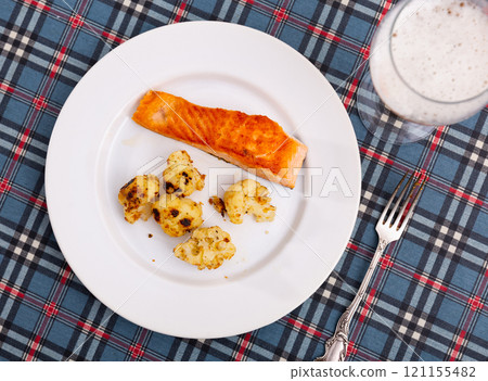 Salmon with cauliflower on a white plate Salmon with cauliflower on a white plate 121155482