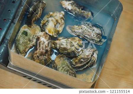 Shucking oysters Photo courtesy of Pier Bandai Shucking oysters Photo courtesy of Pier Bandai 121155514