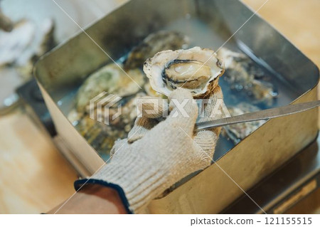 Shucking oysters Photo courtesy of Pier Bandai Shucking oysters Photo courtesy of Pier Bandai 121155515