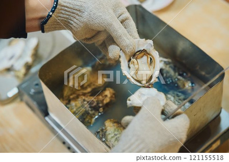 Shucking oysters Photo courtesy of Pier Bandai Shucking oysters Photo courtesy of Pier Bandai 121155518