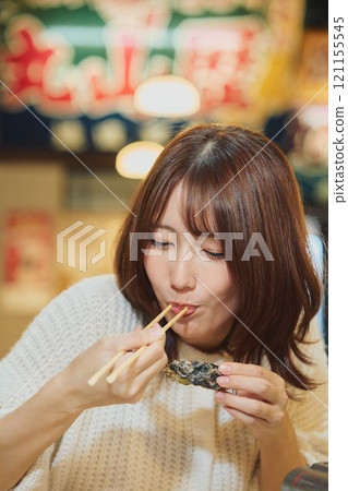 A woman eating oysters with relish. Photo courtesy of Pier Bandai. A woman eating oysters with relish. Photo courtesy of Pier Bandai. 121155545