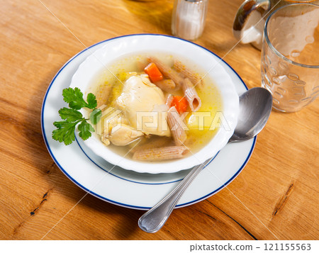Delicious chicken soup with pasta and carrots Delicious chicken soup with pasta and carrots 121155563