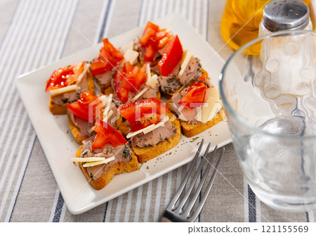 There are sandwiches canape with pate, cheese and tomato on plate. 121155569
