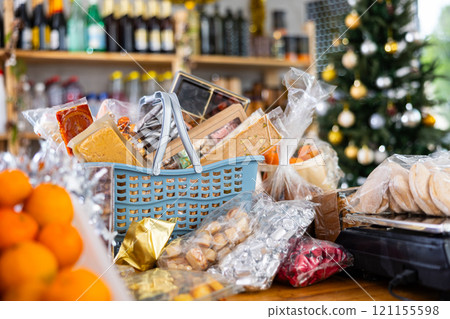 Different products in basket on counter of grocery store Different products in basket on counter of grocery store 121155598