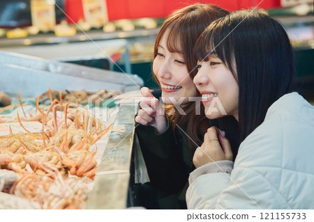 Women enjoying the fish market. Photo courtesy of Pier Bandai. 121155733