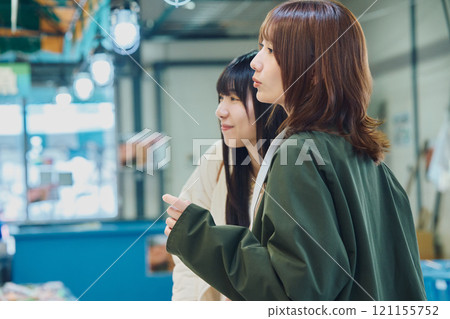 Women enjoying the fish market. Photo courtesy of Pier Bandai. 121155752