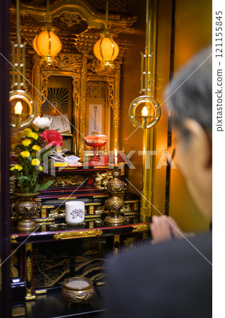 A man visiting a grave 121155845