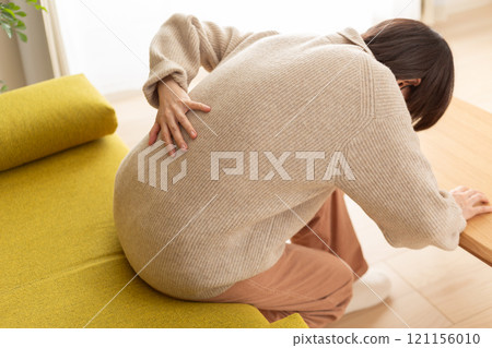 Middle-aged to senior women suffering from back pain 121156010
