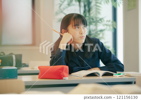 A high school girl struggling with her studies A high school girl struggling with her studies 121156130