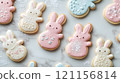 Whimsical bunny shaped cookies in pastel colors on marble surface 121156814