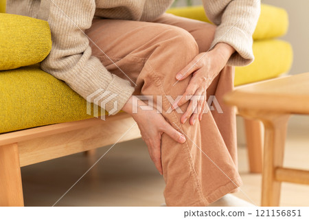 Middle-aged to senior women suffering from pain in their calves 121156851